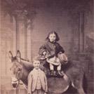 Two children with a donkey